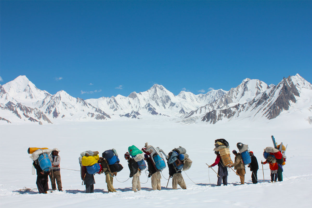 Porters in snow lake